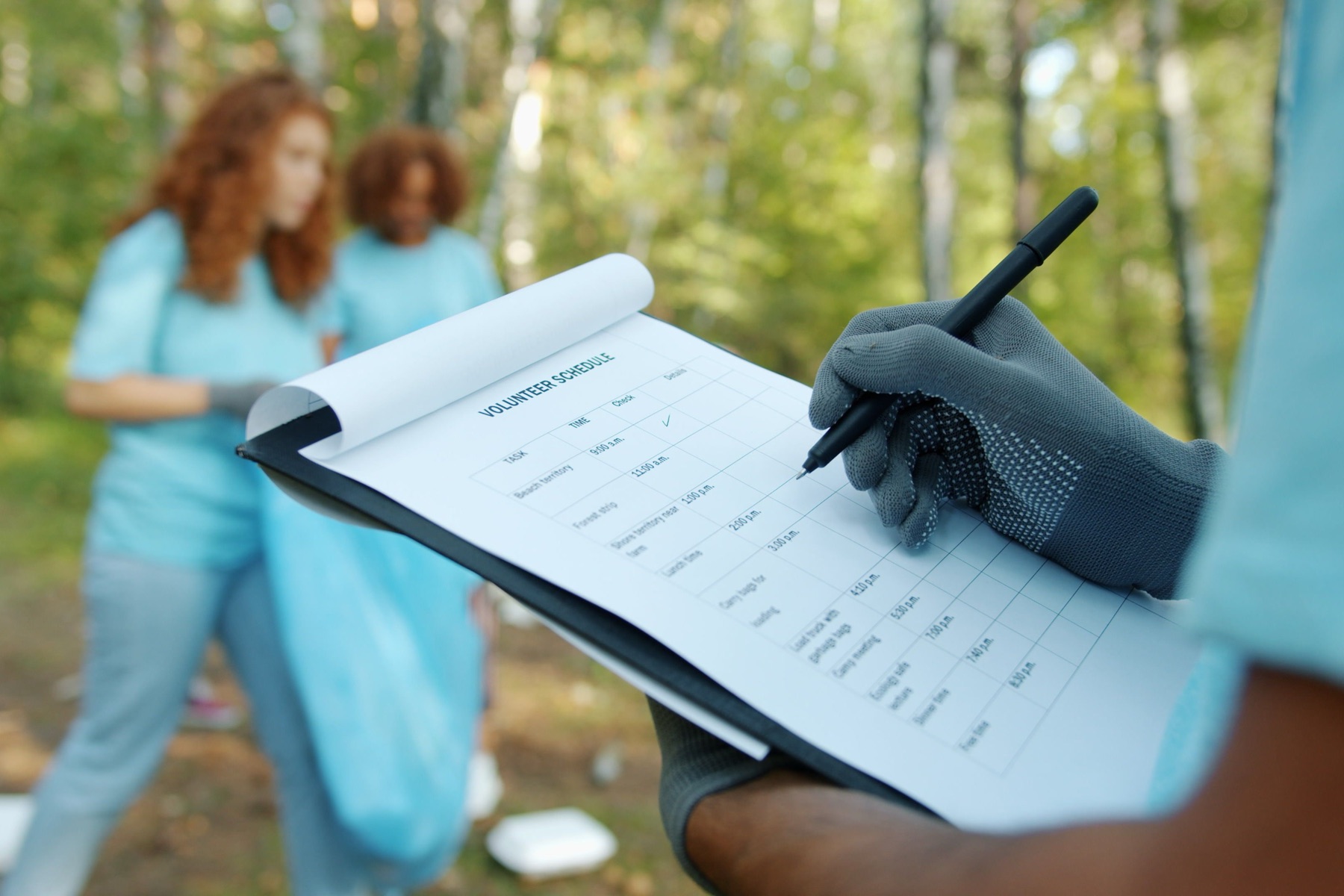Environmental team recording field observations on a clipboard