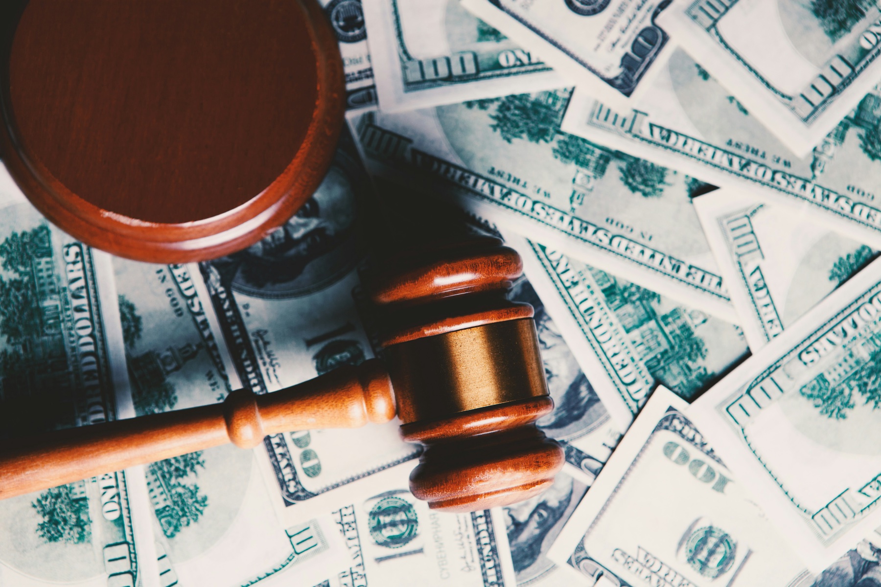 Judge's gavel resting on currency, representing sustainable finance regulation