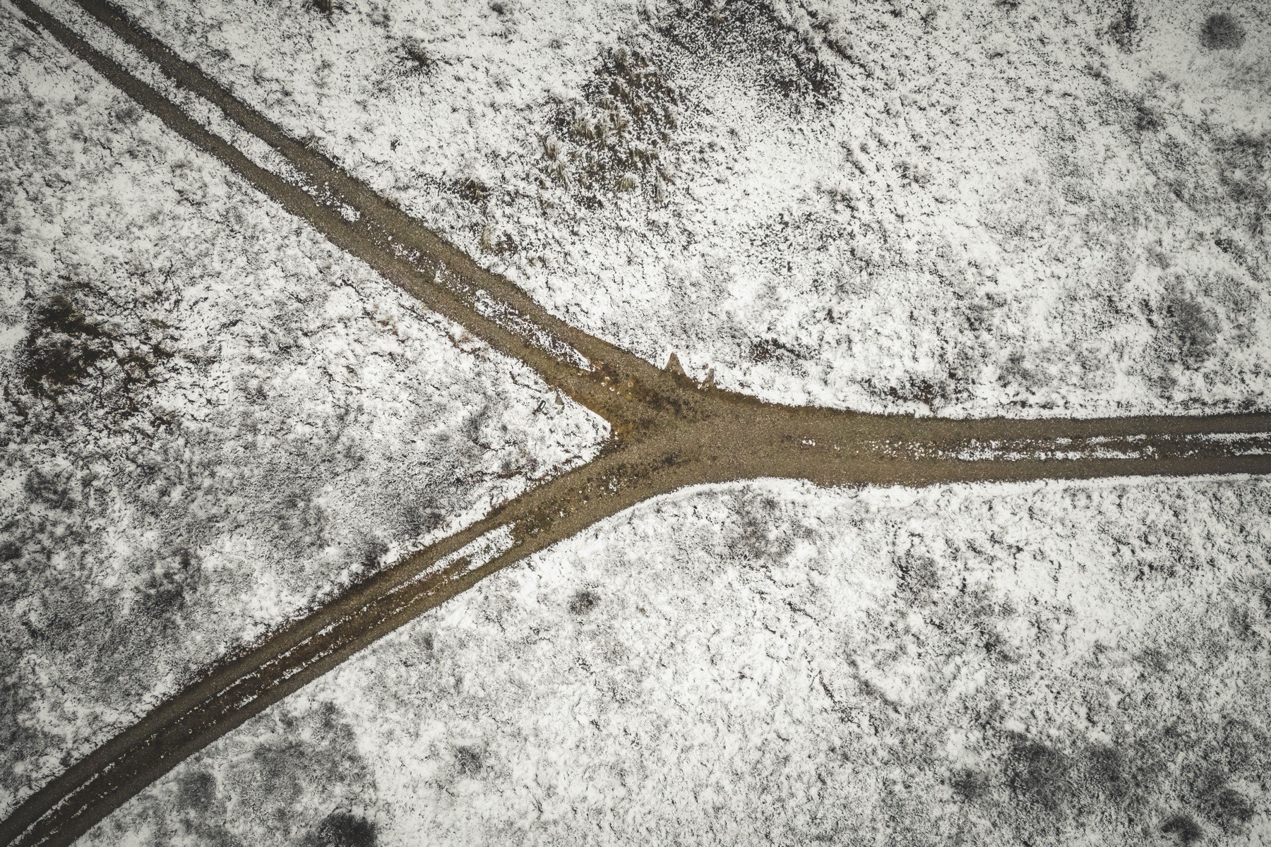 Three-way fork in a snowy path, representing a choice between ESG reporting approaches