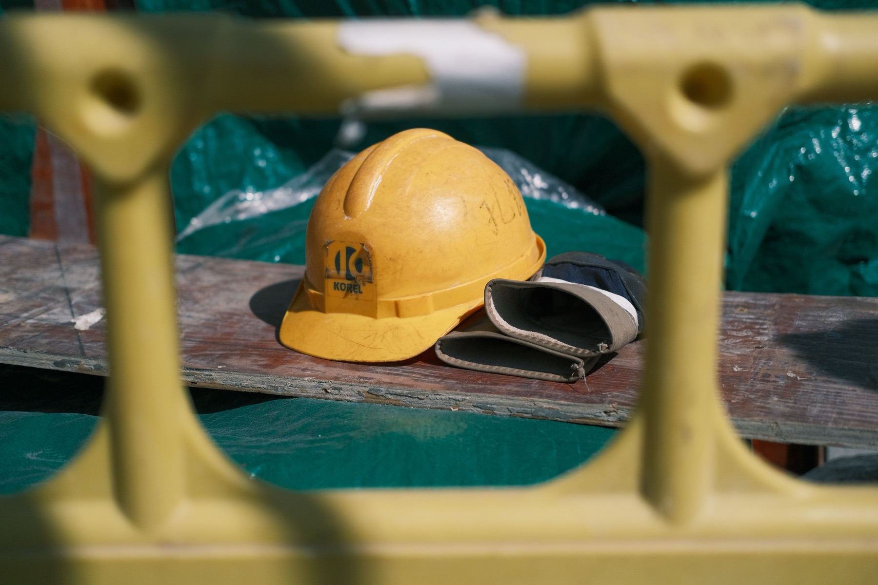 Safety helmet and protective gloves at an industrial worksite